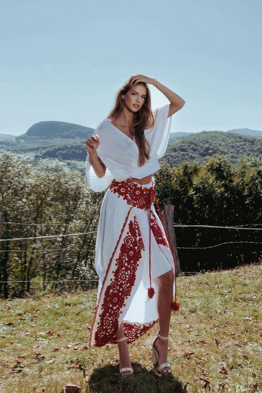 Model in white and red embroidered garment